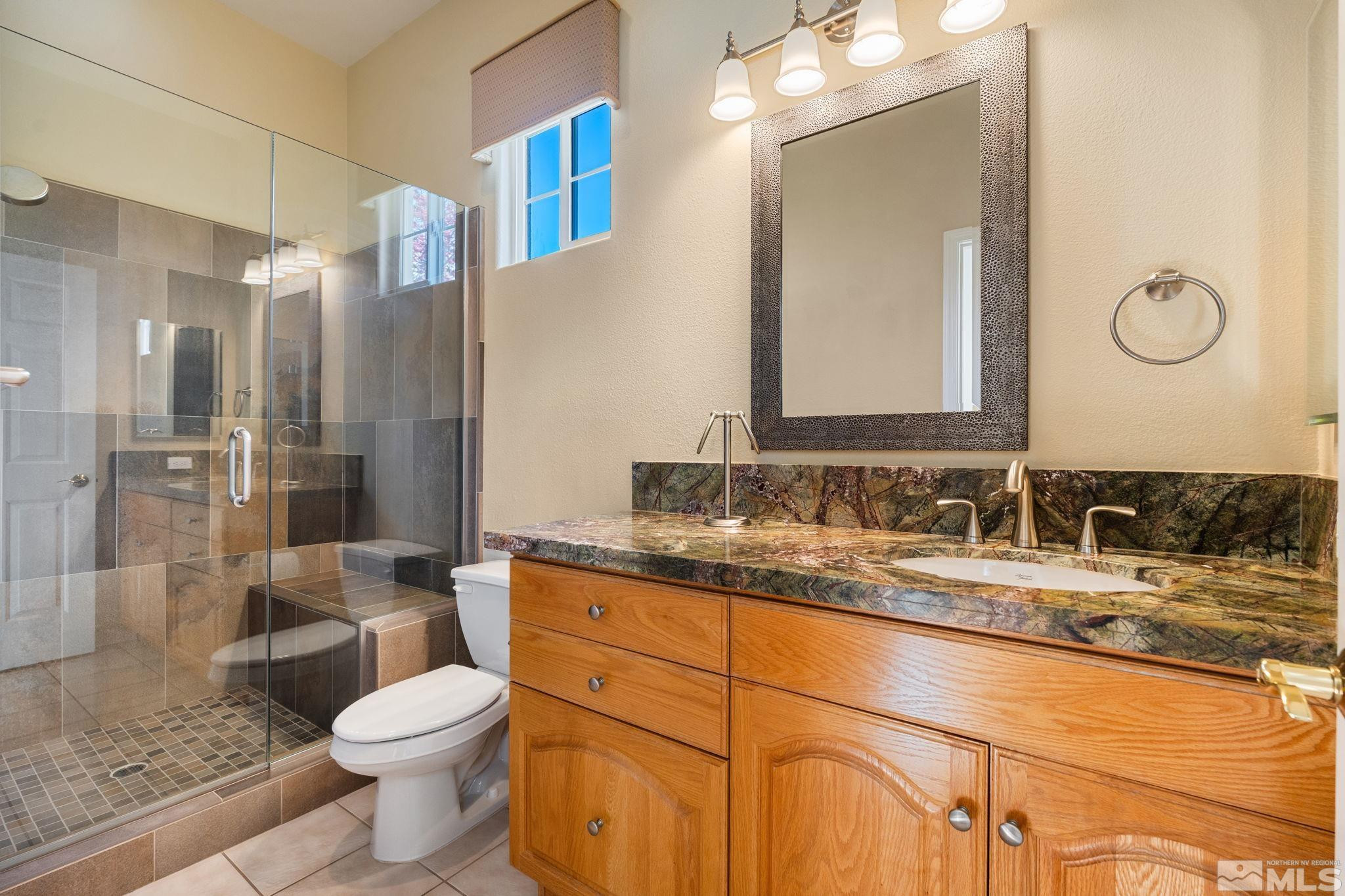 1745 Hunter Creek Road Reno, NV 89519 - Photo 34 of 40 a bathroom with a granite countertop toilet sink shower and mirror