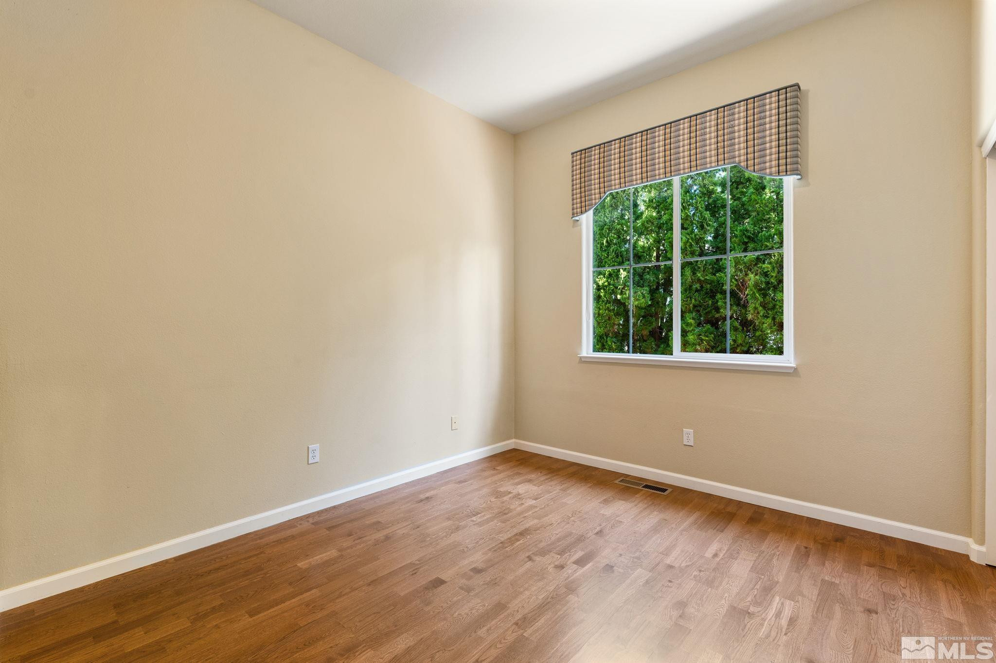 1745 Hunter Creek Road Reno, NV 89519 - Photo 35 of 40 an empty room with wooden floor and windows