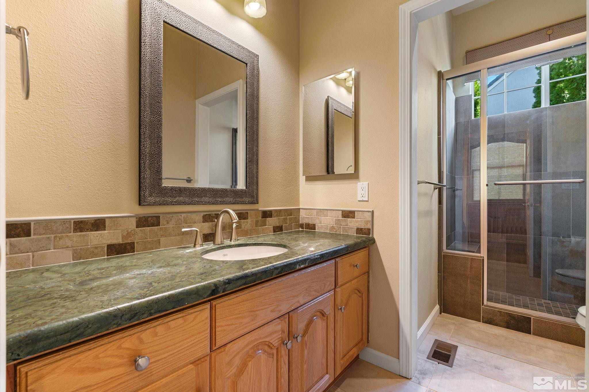 1745 Hunter Creek Road Reno, NV 89519 - Photo 36 of 40 a bathroom with double sink and a mirror