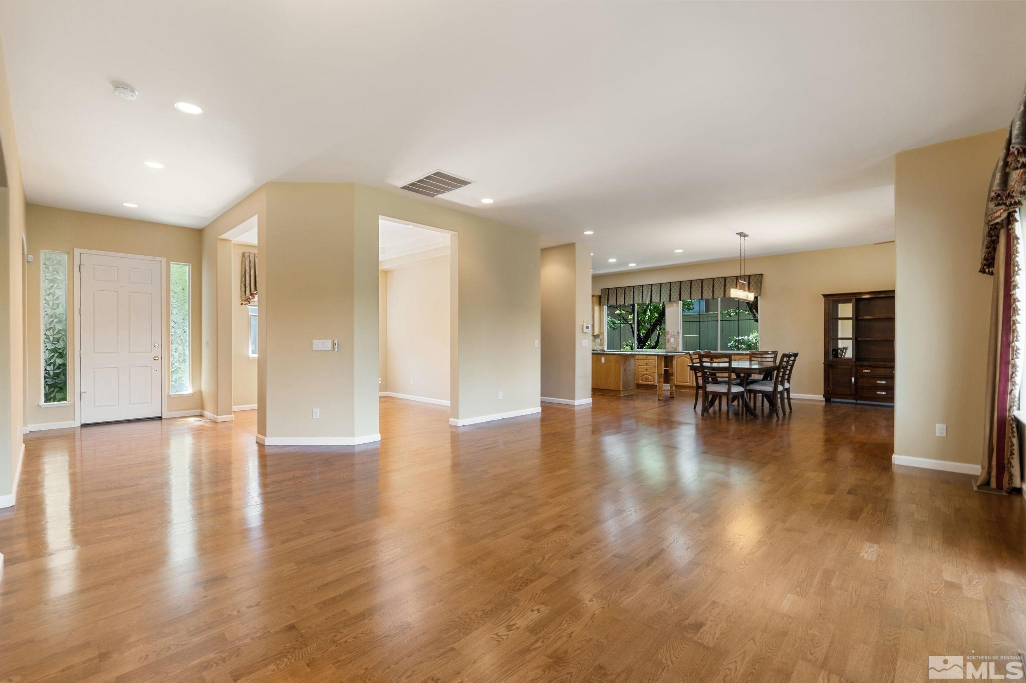 1745 Hunter Creek Road Reno, NV 89519 - Photo 4 of 40 a view of empty room with wooden floor and dining room