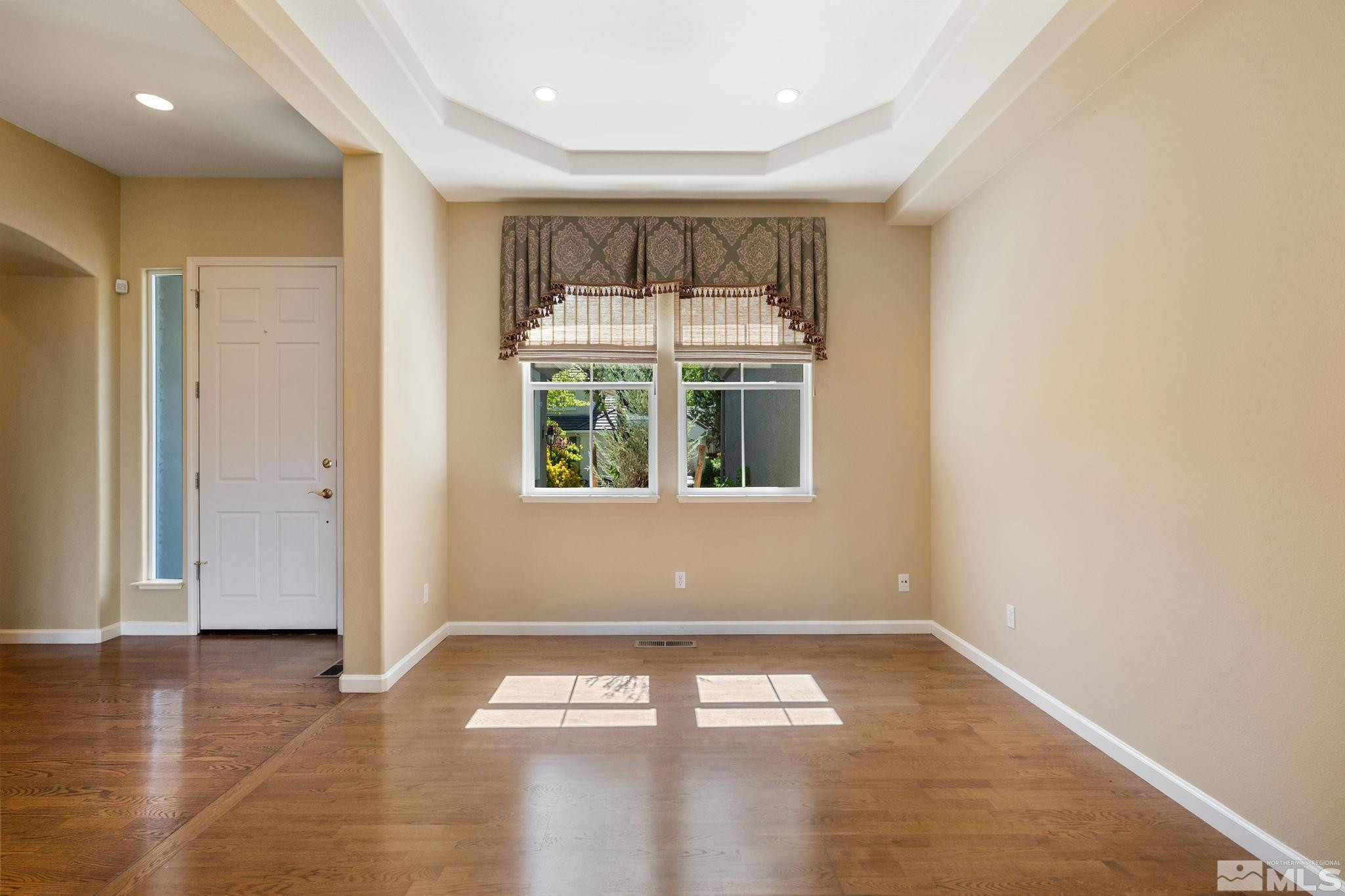 1745 Hunter Creek Road Reno, NV 89519 - Photo 8 of 40 a view of empty room with wooden floor and fan