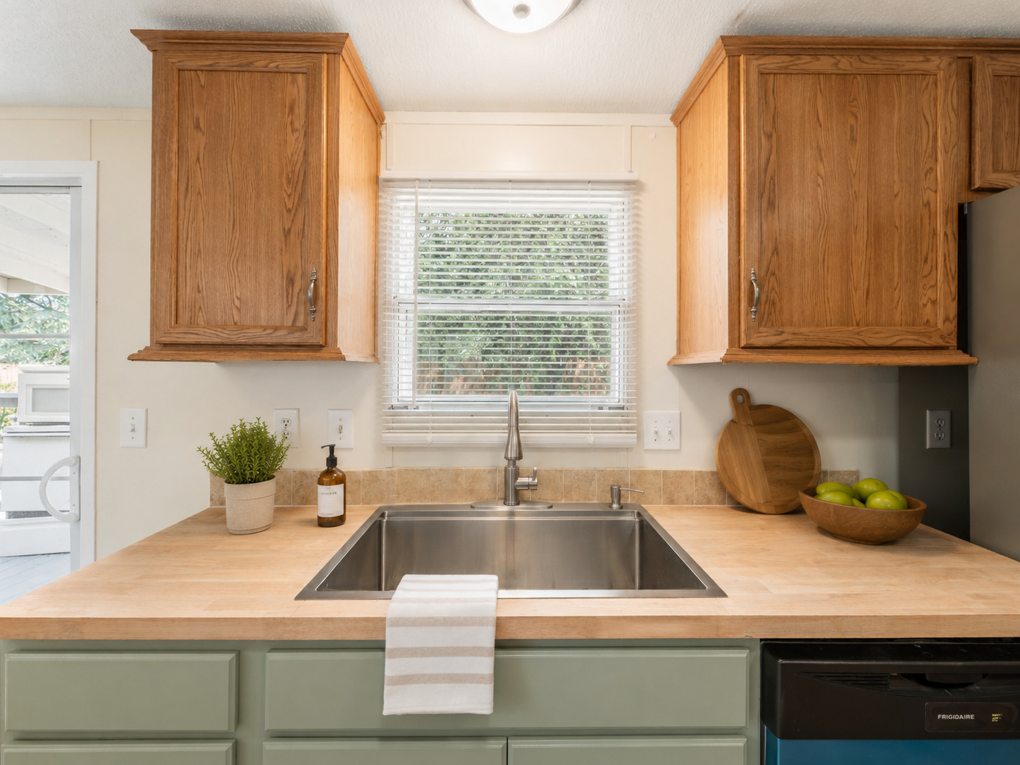 171 Railyard Drive Kyle, TX 78640 - Photo 8 of 20 a kitchen with a sink and potted plant