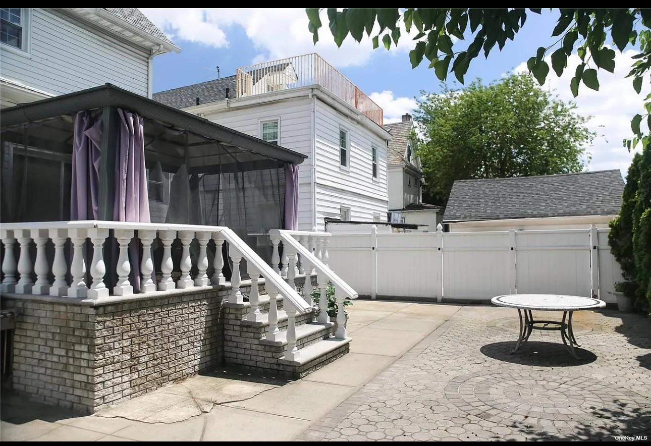94-18 Lefferts Boulevard Queens, NY 11419 - Photo 3 of 8 View of patio with a gate and a sunroom