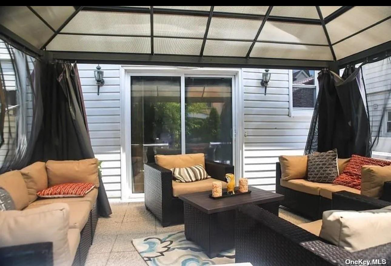 94-18 Lefferts Boulevard Queens, NY 11419 - Photo 4 of 8 Sunroom featuring an outdoor living space and healthy amount of natural light