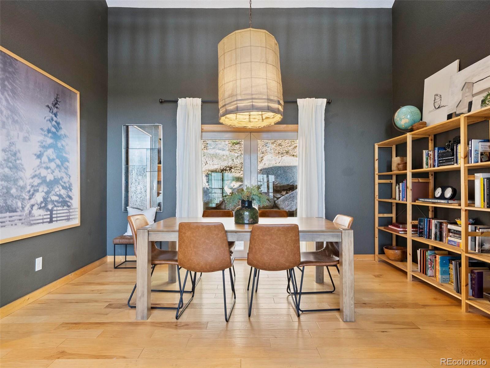 8335 Doubleheader Ranch Road Morrison, CO 80465 - Photo 17 of 40 a dining room with furniture and window