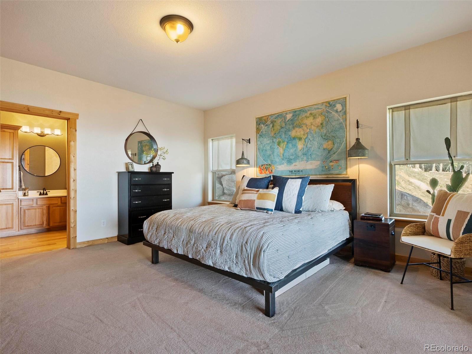 8335 Doubleheader Ranch Road Morrison, CO 80465 - Photo 20 of 40 a living room with a bed furniture and a window