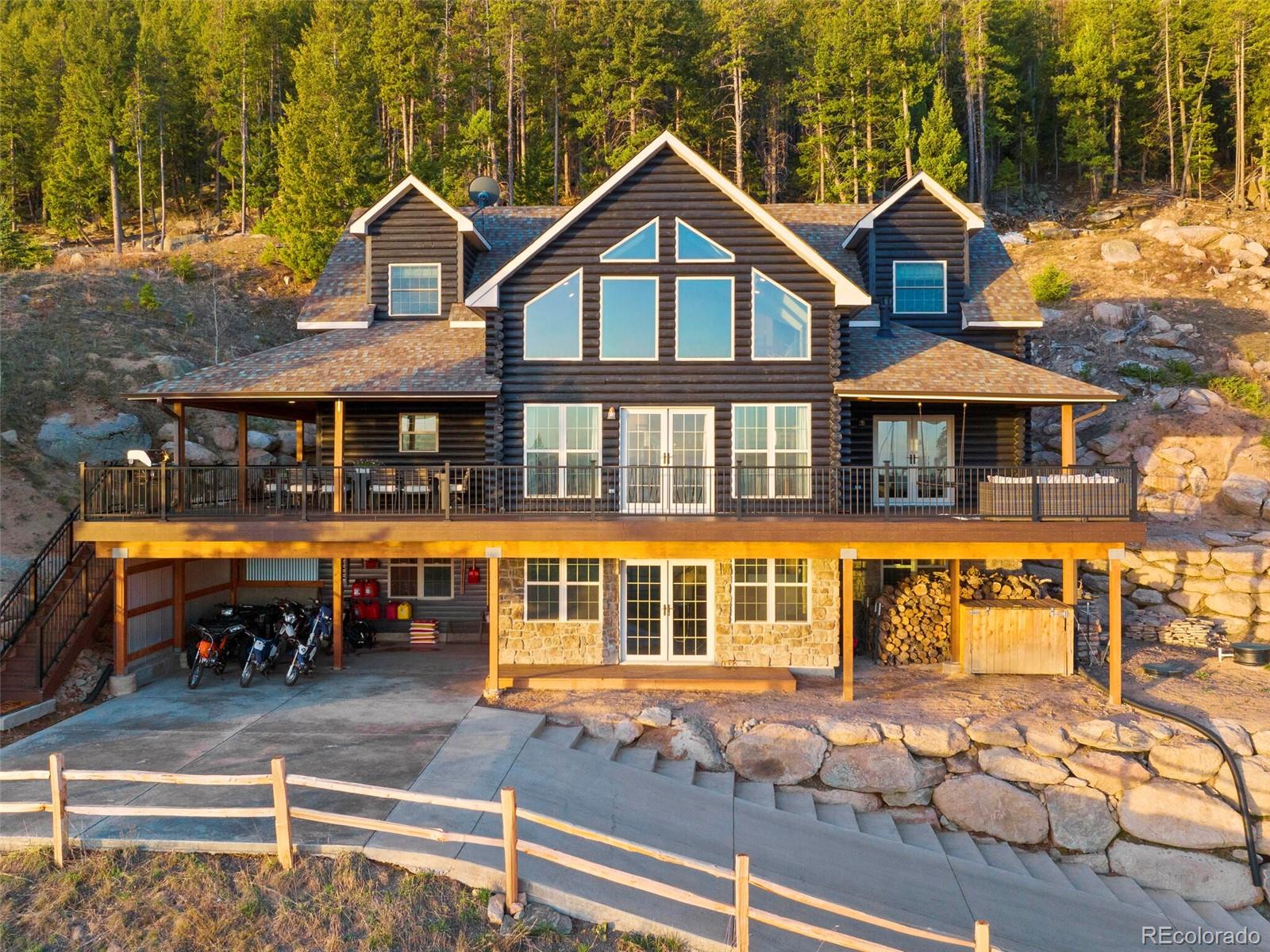 8335 Doubleheader Ranch Road Morrison, CO 80465 - Photo 2 of 40 a front view of a house with a yard