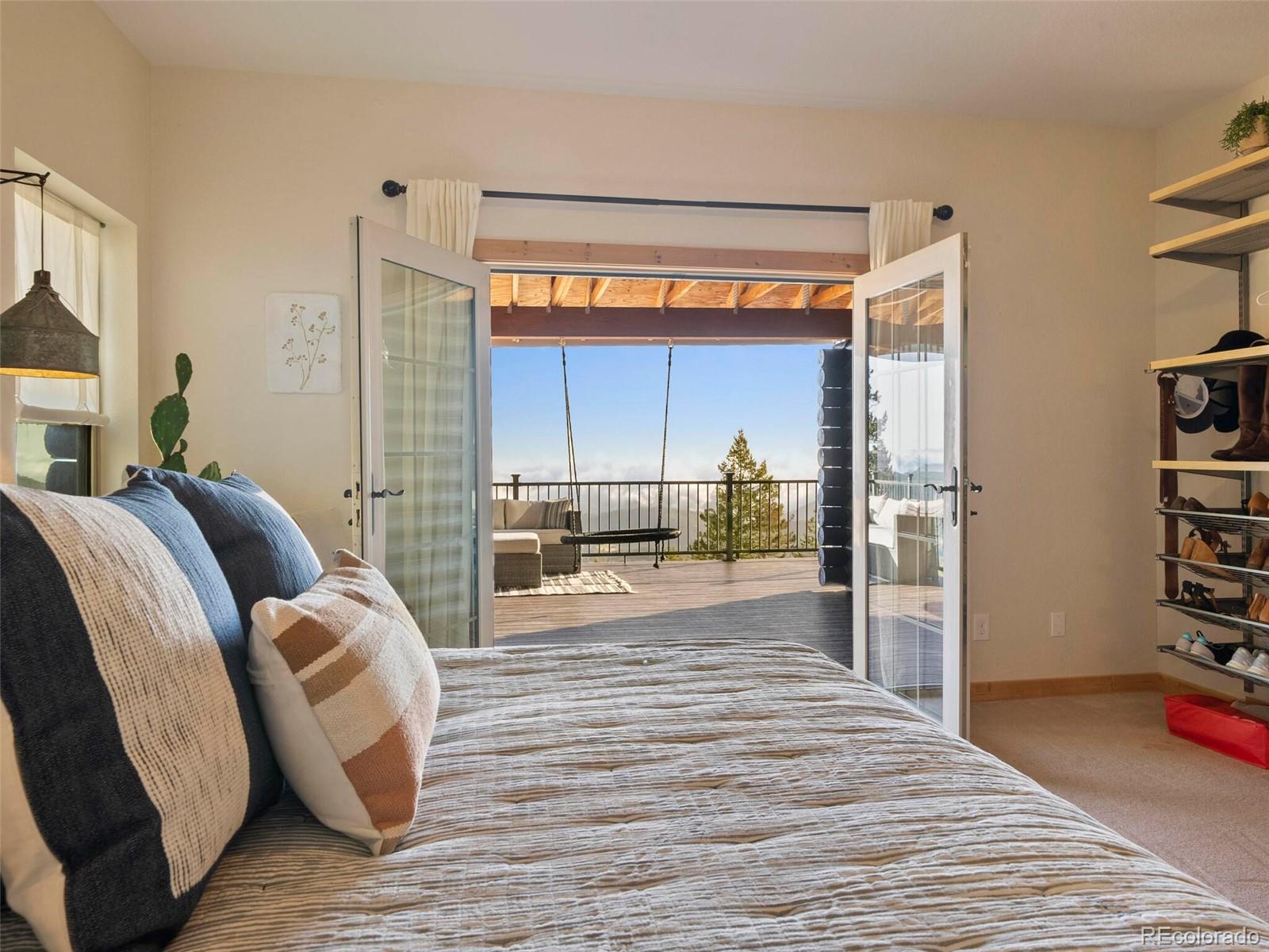 8335 Doubleheader Ranch Road Morrison, CO 80465 - Photo 23 of 40 a bedroom with furniture and a window