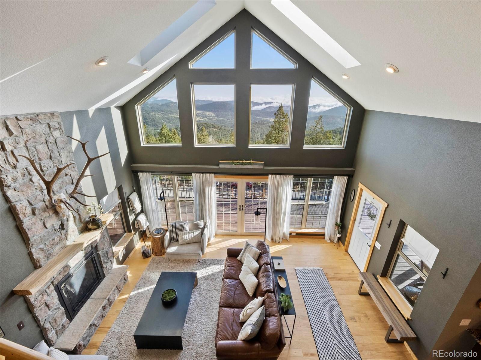 8335 Doubleheader Ranch Road Morrison, CO 80465 - Photo 25 of 40 a living room with furniture and a large window