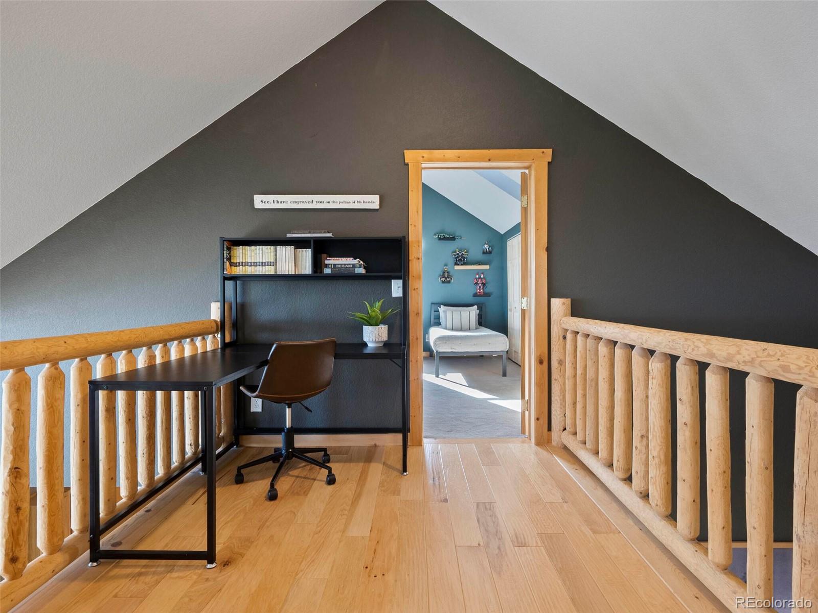 8335 Doubleheader Ranch Road Morrison, CO 80465 - Photo 26 of 40 a view of a hallway with wooden floor and furniture
