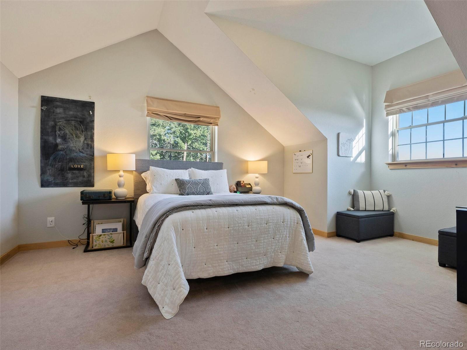 8335 Doubleheader Ranch Road Morrison, CO 80465 - Photo 28 of 40 a spacious bedroom with a bed and window
