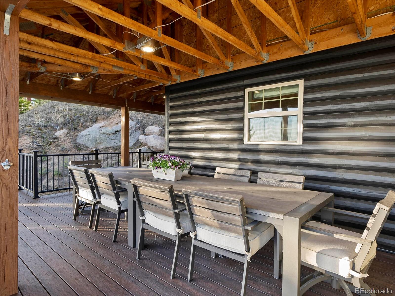 8335 Doubleheader Ranch Road Morrison, CO 80465 - Photo 30 of 40 a patio with table and chairs