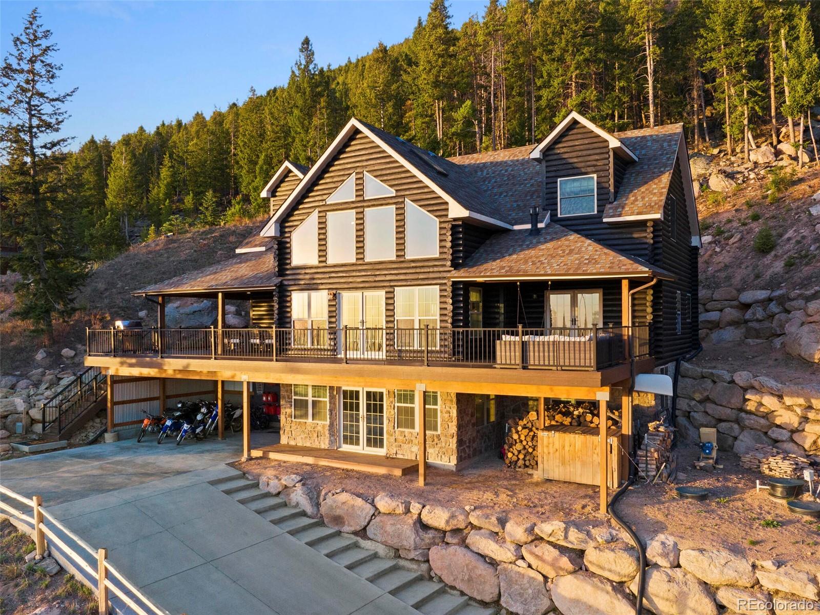8335 Doubleheader Ranch Road Morrison, CO 80465 - Photo 3 of 40 an aerial view of a house with a yard