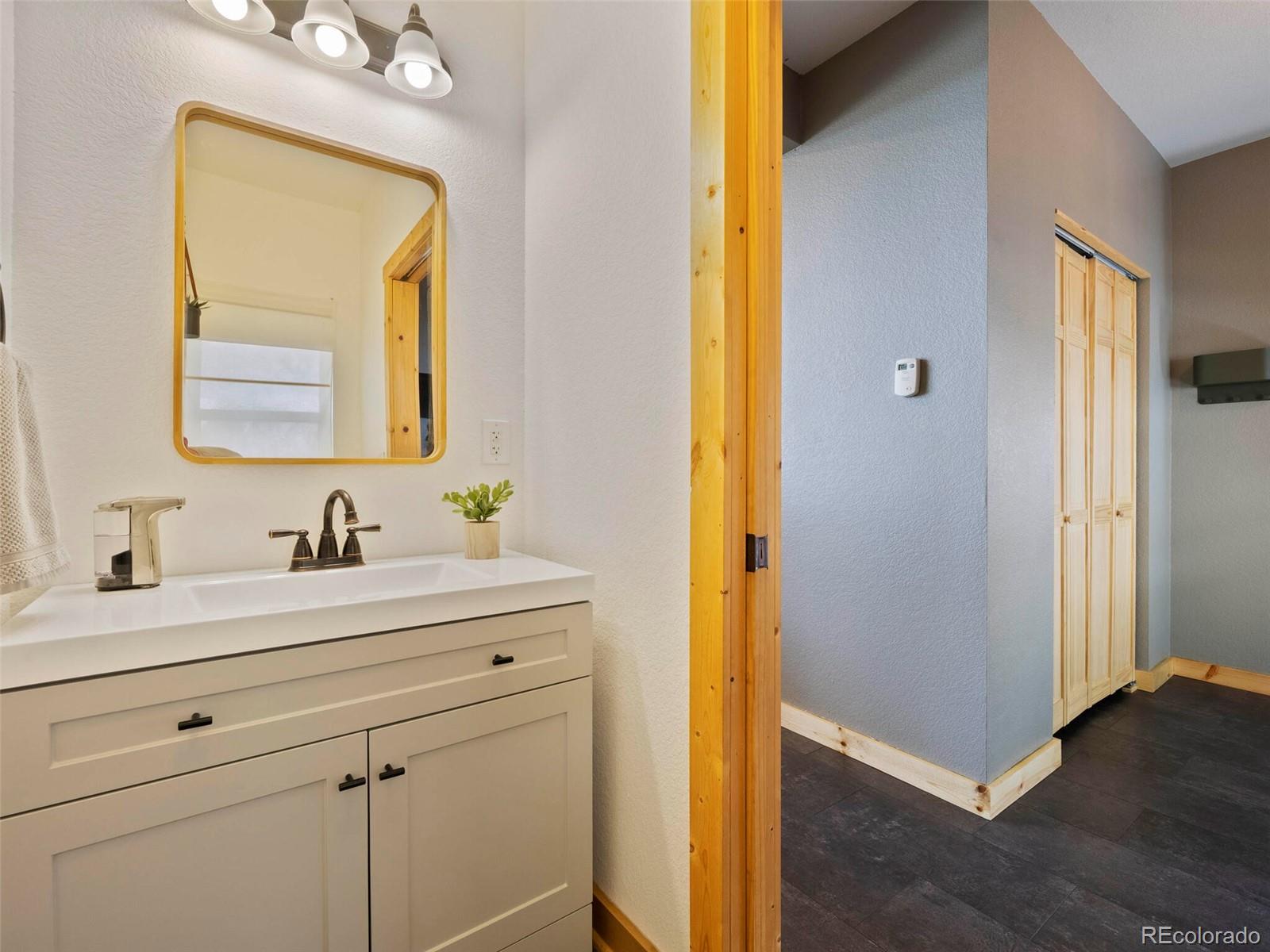 8335 Doubleheader Ranch Road Morrison, CO 80465 - Photo 32 of 40 a bathroom with a sink a mirror and a shower