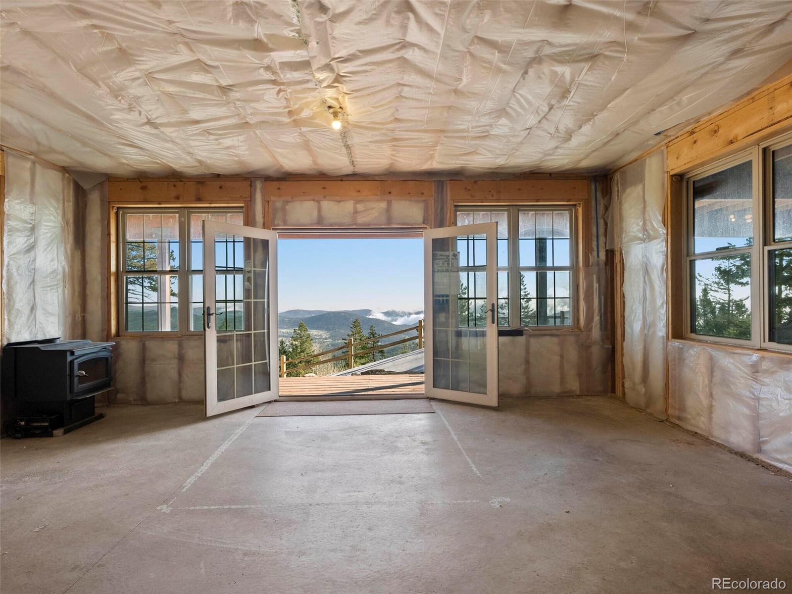 8335 Doubleheader Ranch Road Morrison, CO 80465 - Photo 36 of 40 a view of an empty room and window