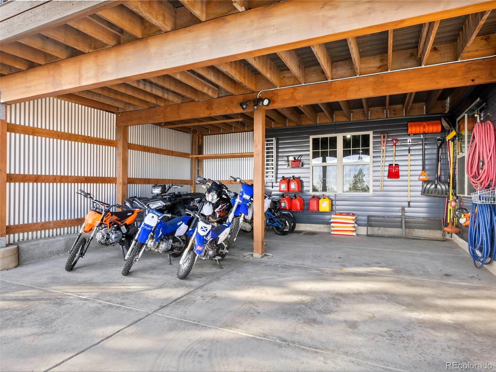 8335 Doubleheader Ranch Road Morrison, CO 80465 - Photo 37 of 40 a view of a garage with rack and bicycle
