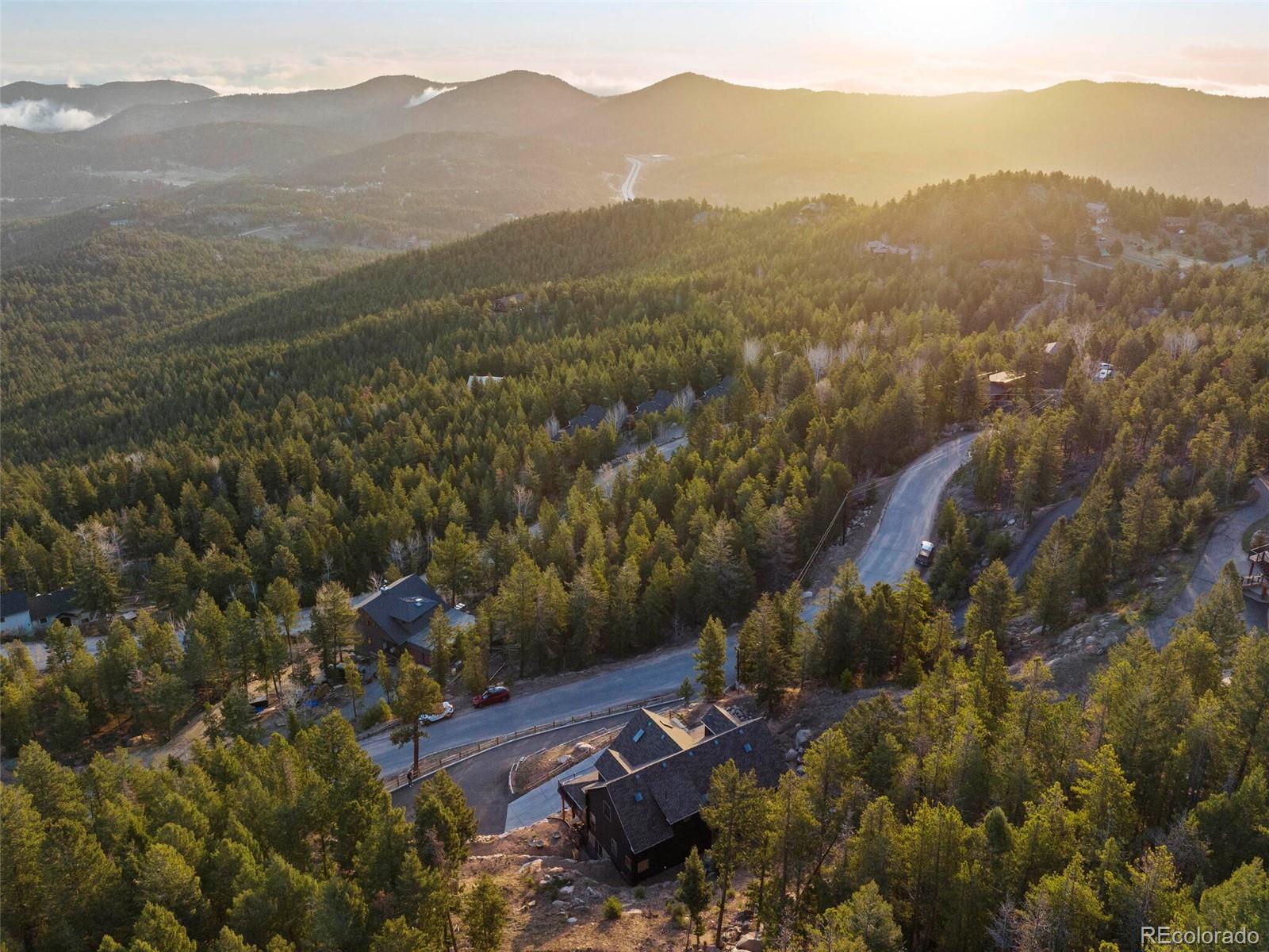 8335 Doubleheader Ranch Road Morrison, CO 80465 - Photo 5 of 40 a view of a town with mountains in the background