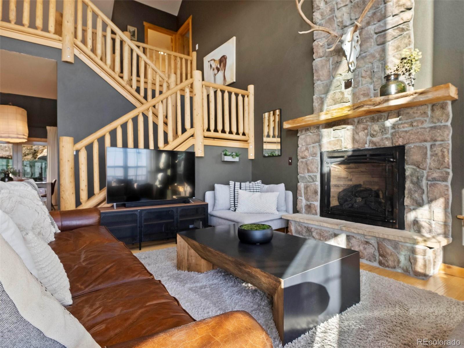 8335 Doubleheader Ranch Road Morrison, CO 80465 - Photo 7 of 40 a living room with furniture and a fireplace