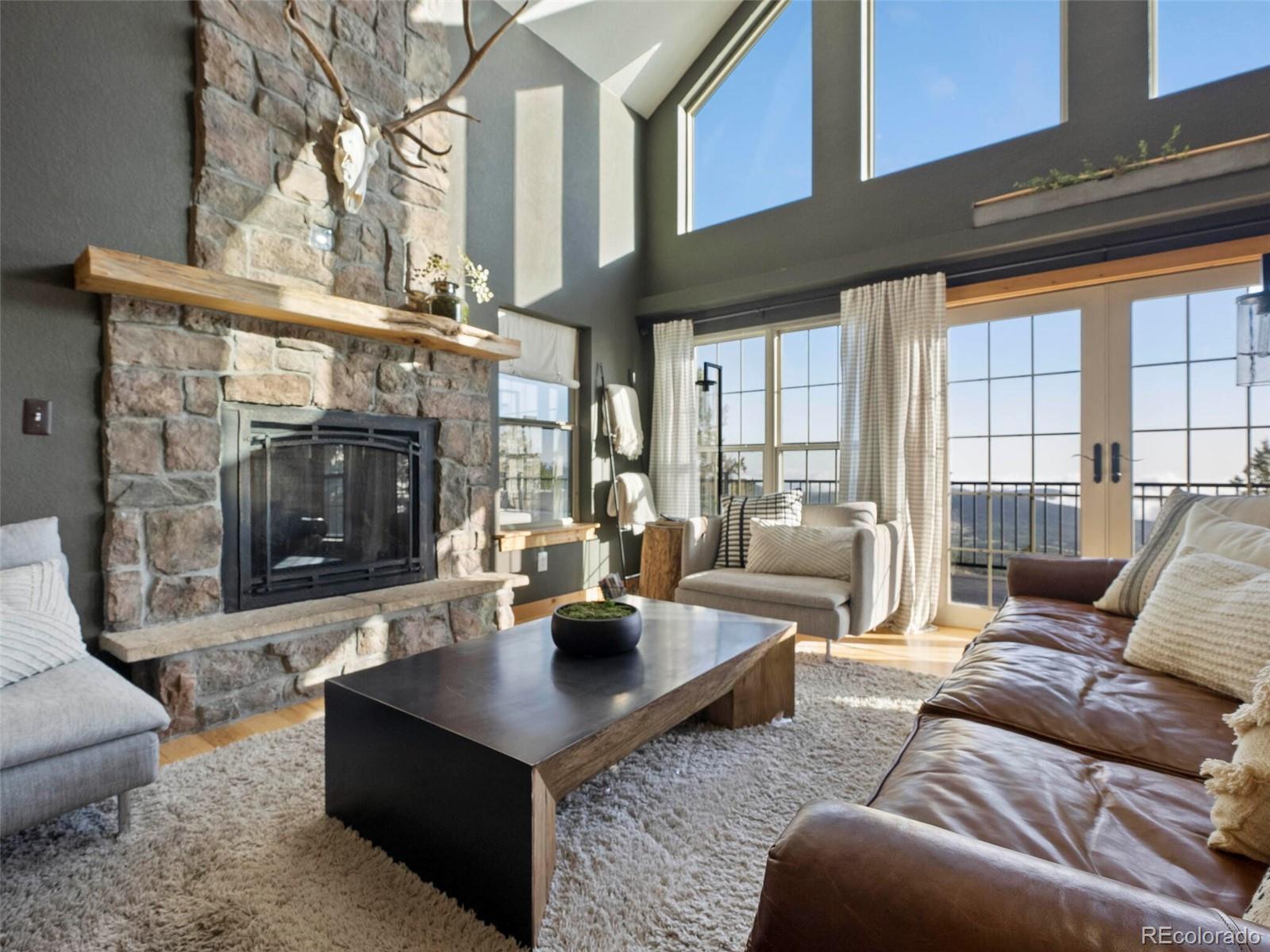 8335 Doubleheader Ranch Road Morrison, CO 80465 - Photo 9 of 40 a living room with furniture and a fireplace