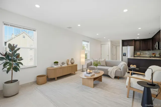 a living room with furniture and a potted plant