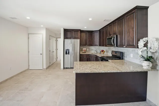a kitchen with stainless steel appliances granite countertop a refrigerator oven a sink and dishwasher