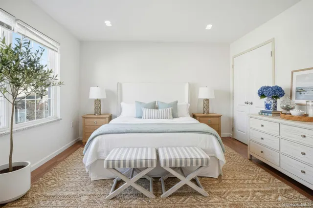 a bedroom with a bed and a mirror