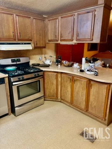 Undisclosed Address Lebec, CA 93243 - Photo 5 of 16 a kitchen with stainless steel appliances granite countertop a stove a sink and a refrigerator