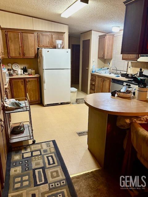 Undisclosed Address Lebec, CA 93243 - Photo 6 of 16 a kitchen with a refrigerator and a stove top oven