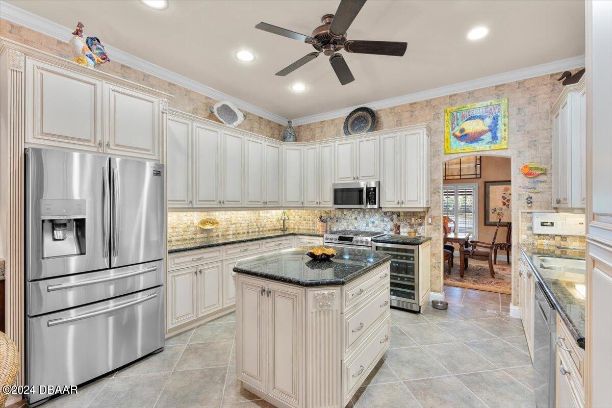 6 Old Canyon Lane Ormond Beach, FL 32174 - Photo 16 of 71 a kitchen with cabinets and stainless steel appliances