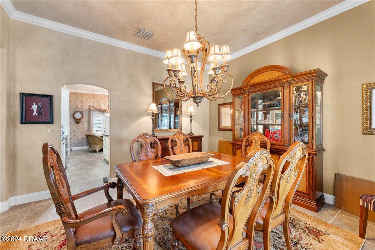 6 Old Canyon Lane Ormond Beach, FL 32174 - Photo 19 of 71 a view of a dining room with furniture and a chandelier