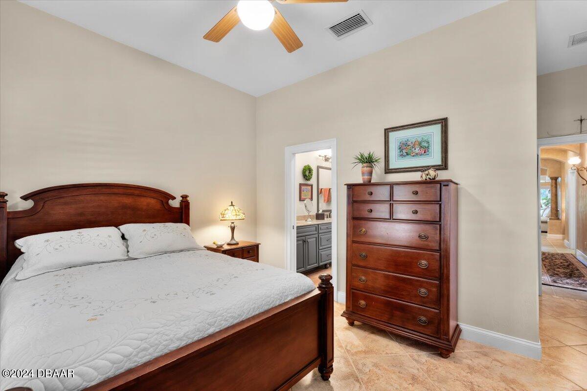 6 Old Canyon Lane Ormond Beach, FL 32174 - Photo 46 of 71 a bedroom with a bed and a chandelier