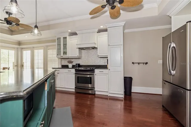 a kitchen with lots of counter and a wooden floors