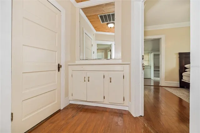 a bed sitting in a spacious bedroom next to a window