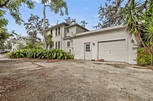 a view of a house with a yard and garage