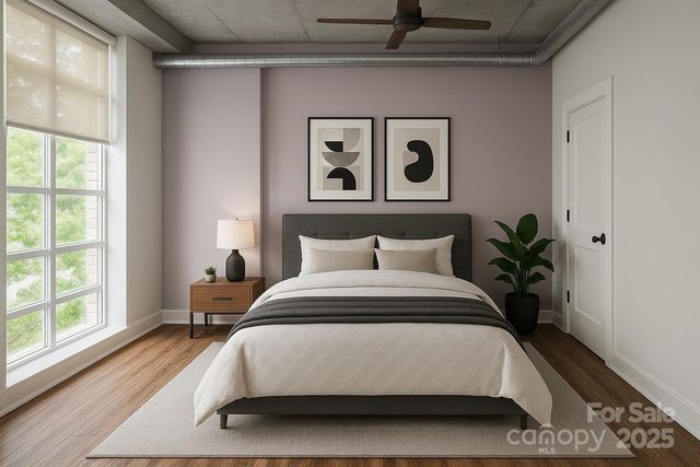 a spacious bedroom with a bed and a large window