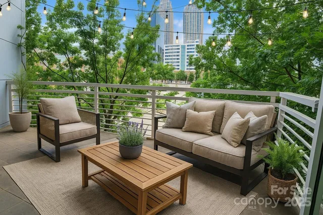 a view of a patio with couches chairs and a potted plant