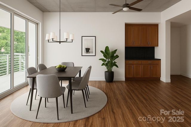 a dining room with furniture potted plants and wooden floor