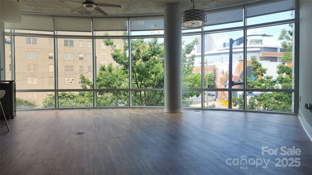 a view of room with window and wooden floor