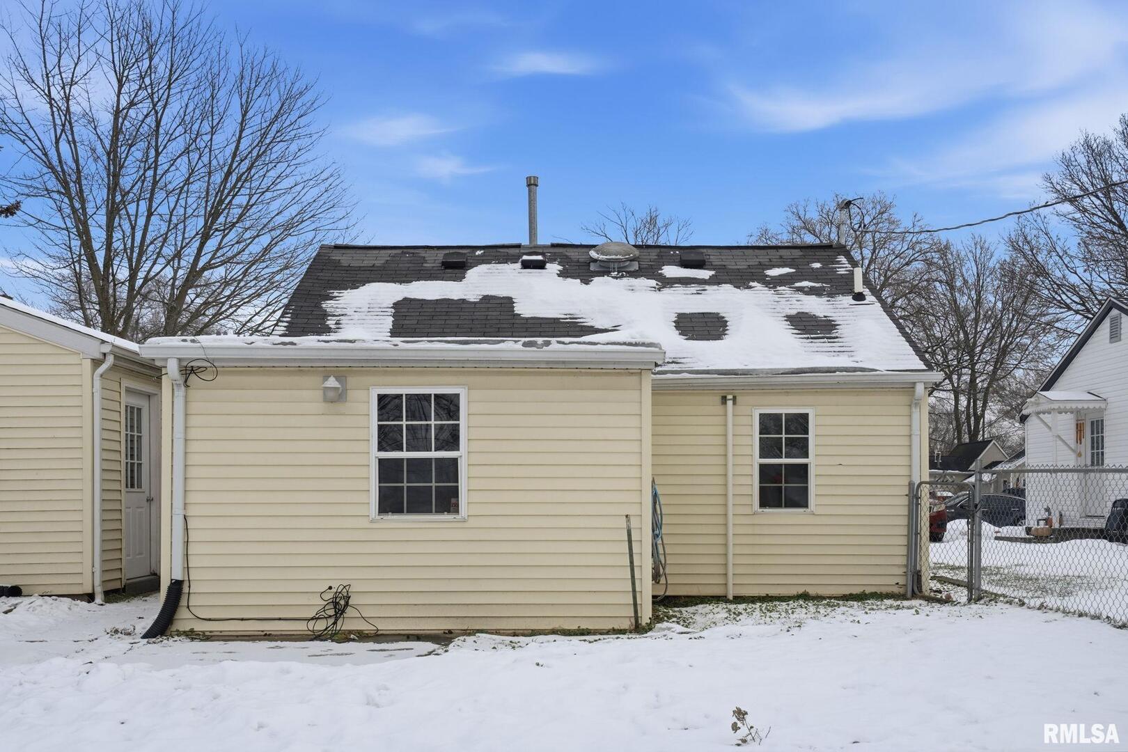 1015 7th Street Colona, IL 61241 - Photo 19 of 19 a view of a white house with a small yard and large tree
