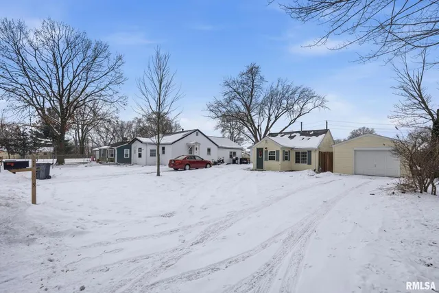 a view of a house with a snow in the yard