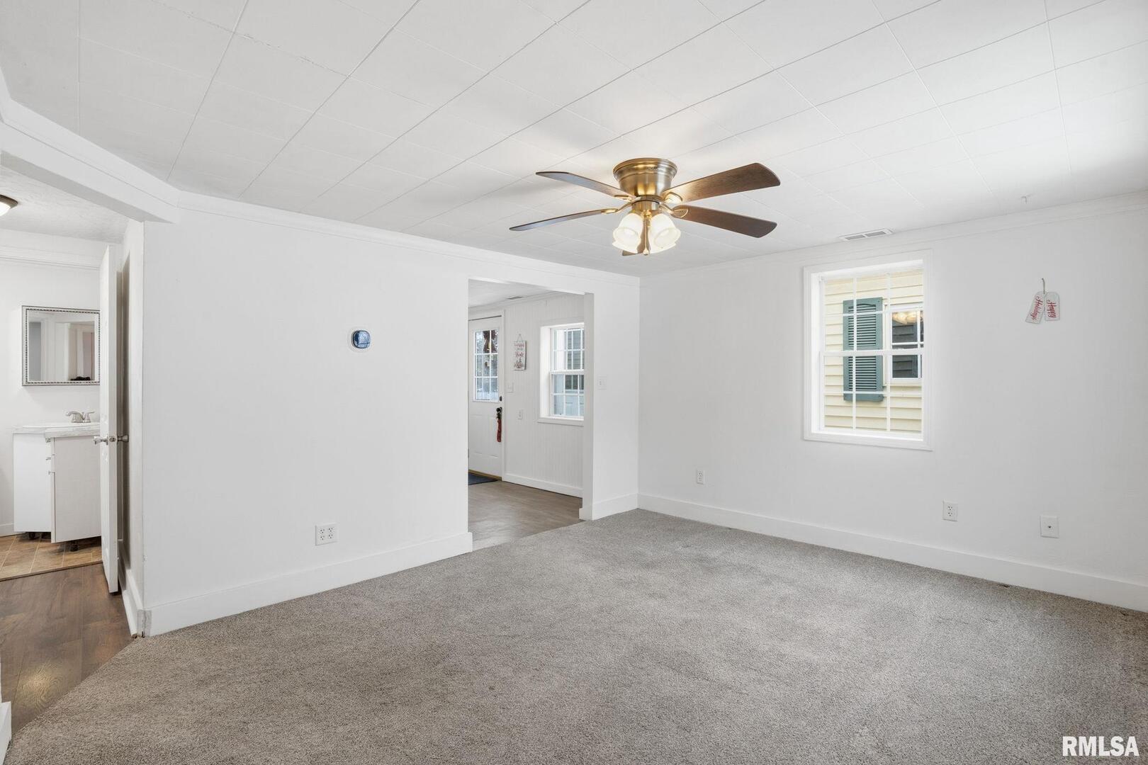 1015 7th Street Colona, IL 61241 - Photo 4 of 19 a view of an empty room with a window