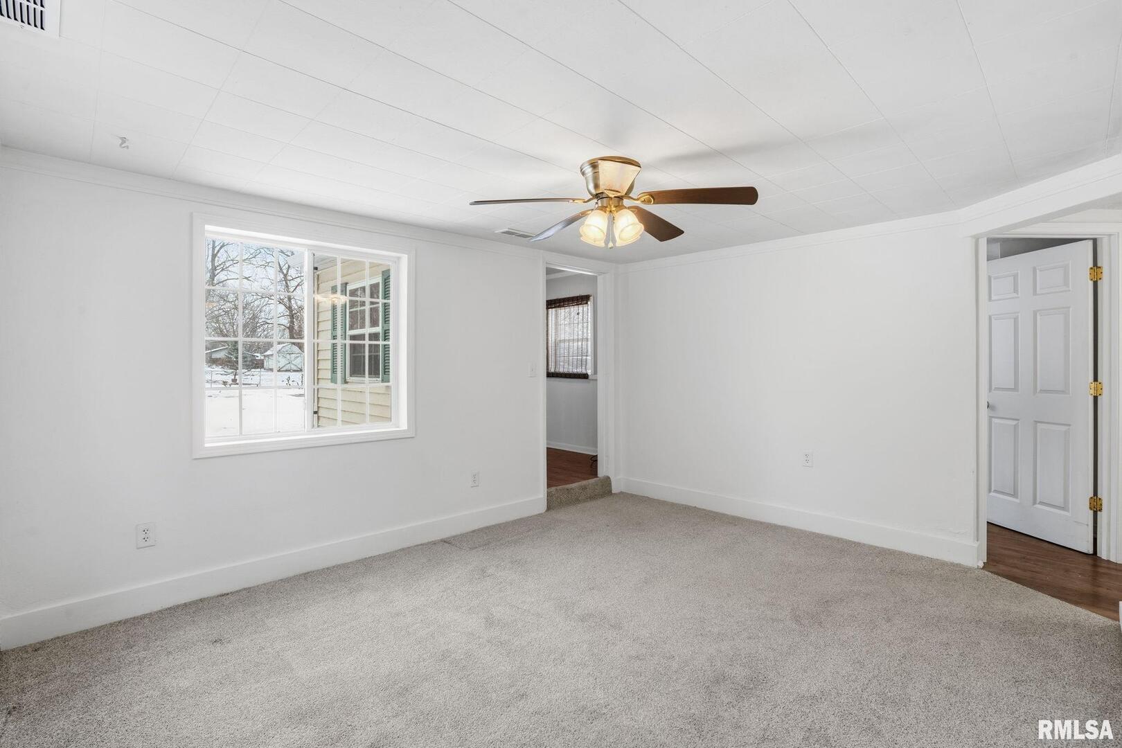 1015 7th Street Colona, IL 61241 - Photo 5 of 19 an empty room with windows and fan