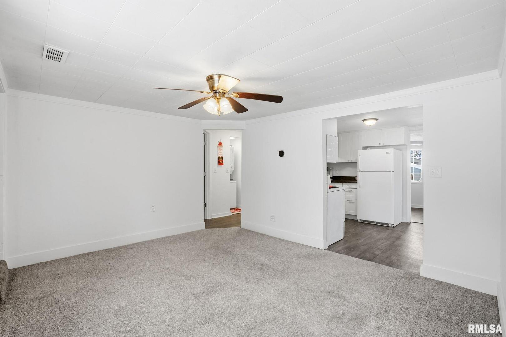 1015 7th Street Colona, IL 61241 - Photo 6 of 19 a view of empty room with wooden floor and window