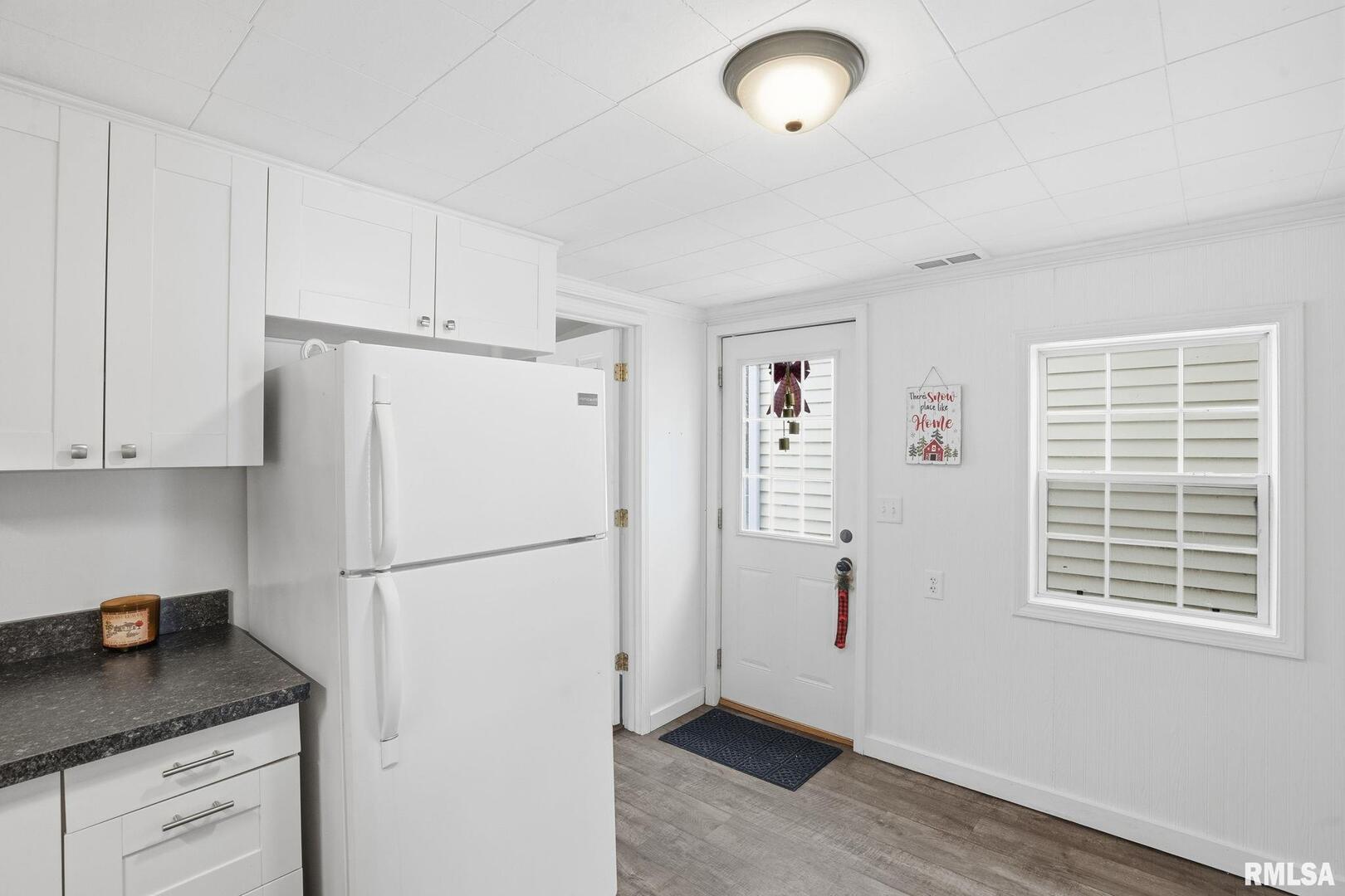 1015 7th Street Colona, IL 61241 - Photo 9 of 19 a white refrigerator freezer sitting in a kitchen