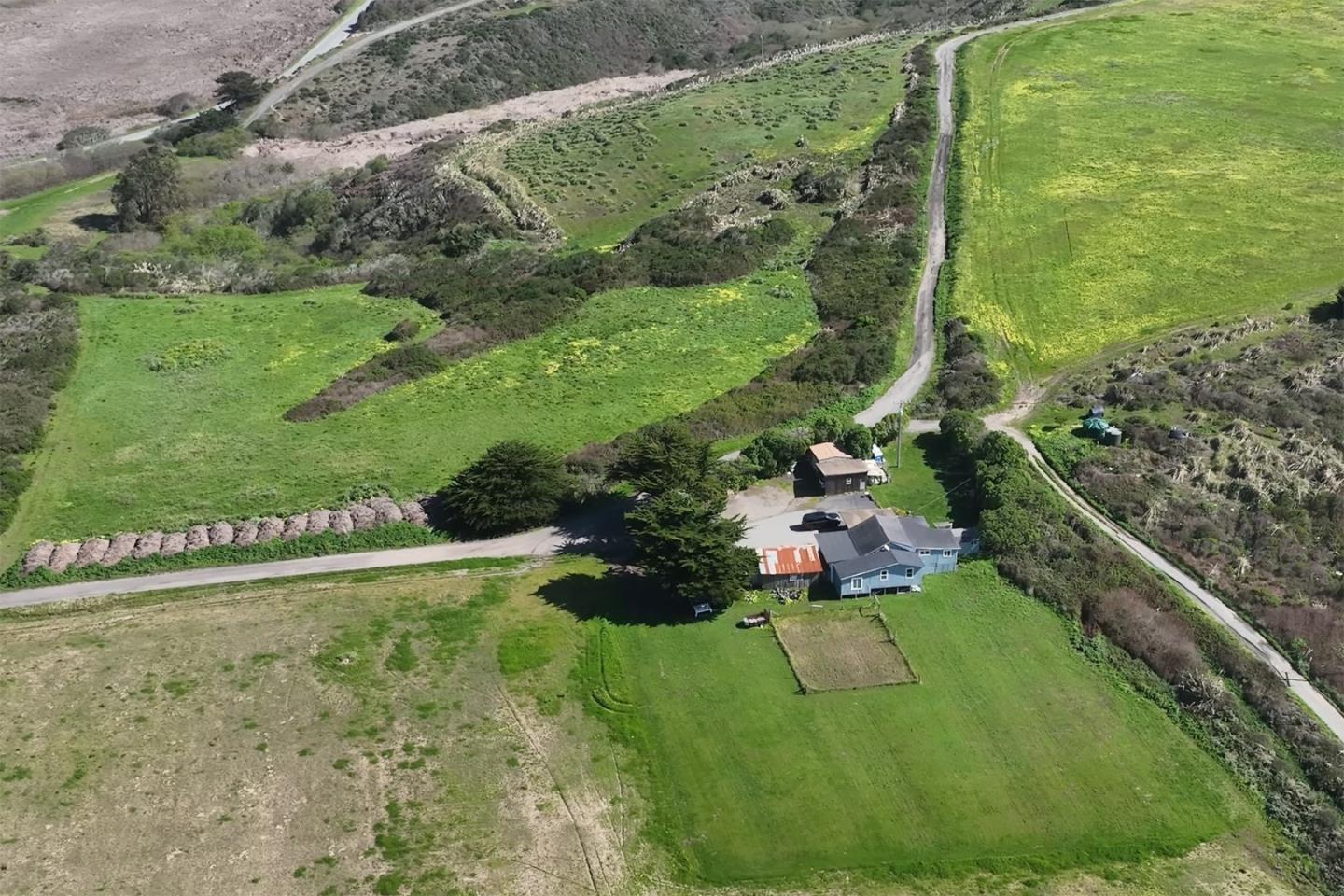 1275 Reservoir Road Pescadero, CA 94060 - Photo 7 of 9 a view of a garden with a building