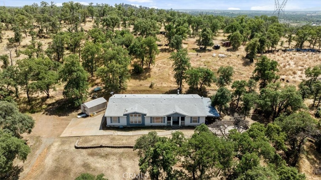 an aerial view of a house with a yard and lake view