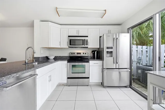 a kitchen with cabinets and appliances