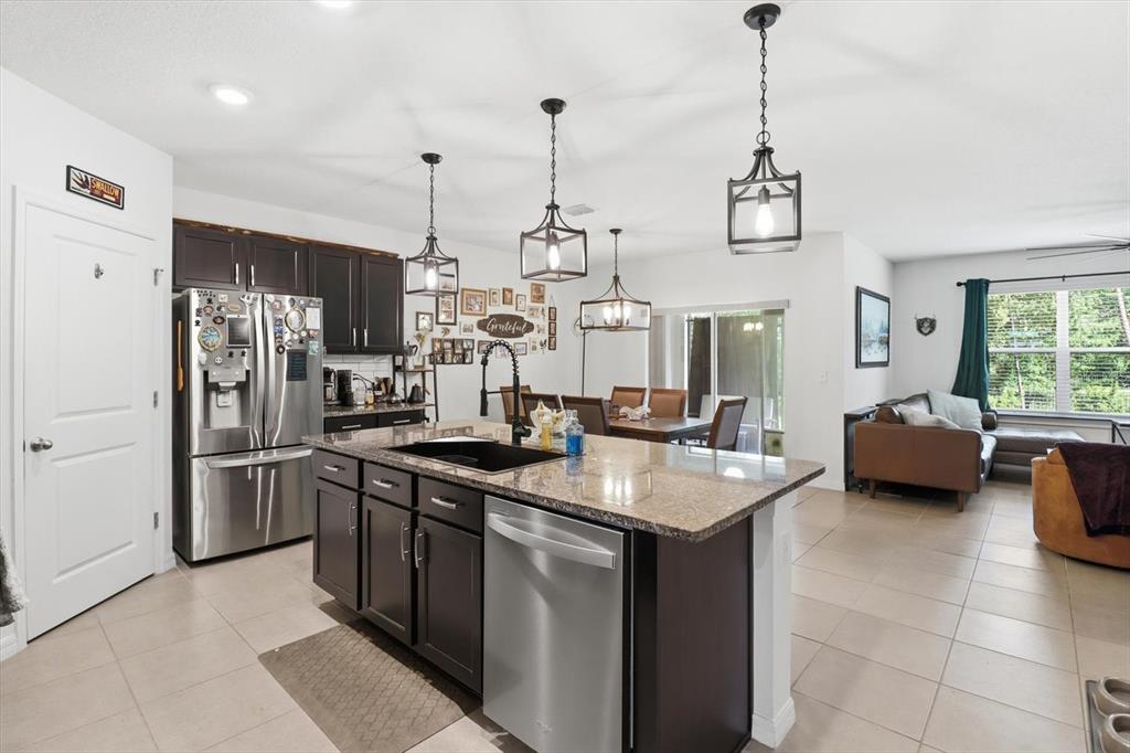 660 Hickory Course Loop Ocala, FL 34472 - Photo 13 of 45 a kitchen with stainless steel appliances granite countertop a sink a stove and a refrigerator