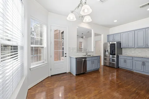a large kitchen with cabinets a stove a sink and dishwasher