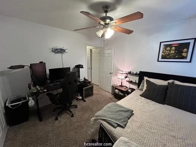 a bedroom with bed and a chandelier